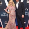 Carrie_Underwood_and_husband_Mike_Fisher_on_2018_CMA_red_carpet.jpg